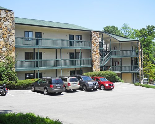 An exterior view of the resort alongside the parking lot.