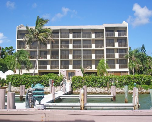 An exterior view of the Sunrise Bay Resort And Club and the waterfront with a pier.