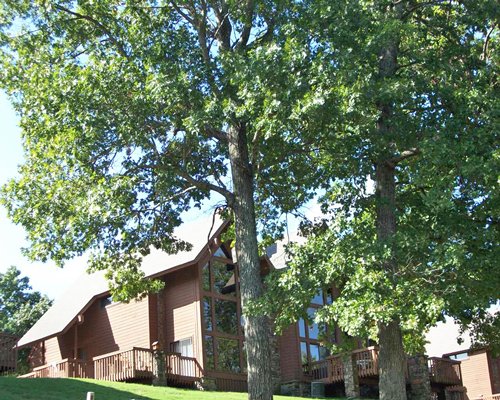 A ground view of the multiple units of the resort with the trees.