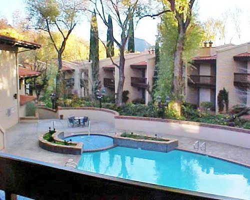 Scenic exterior view of Arroyo Roble Resort with outdoor swimming pool and hot tub.