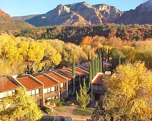 Exterior view of the Arroyo Roble Resort surrounded by wooded area alongside mountains.