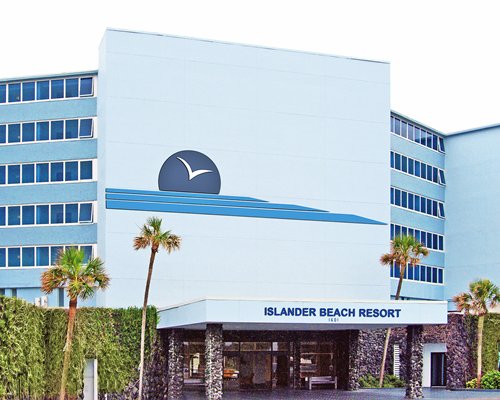 An exterior view of Islander Beach Resort with palm trees.