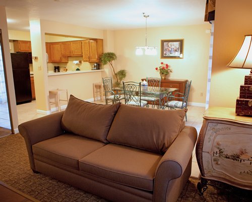 A well furnished living room with open plan kitchen and dining area.