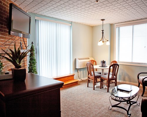 A well furnished living room with television and outside view.