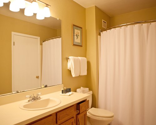 A bathroom with an open sink vanity.