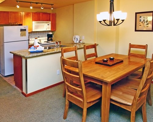A well furnished dining area alongside the kitchen.