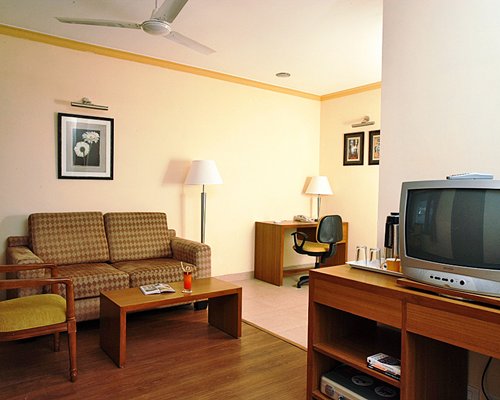 A well furnished living room with television and common area.