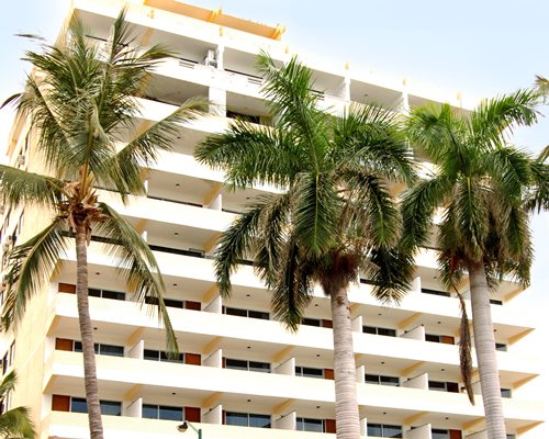 An exterior view of the Hotel Playa Bonita resort with coconut trees.