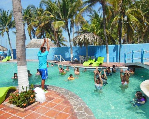 People exercising in the outdoor swimming pool at the resort.