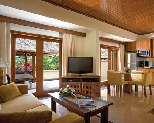 An open plan living and dining area with a television.