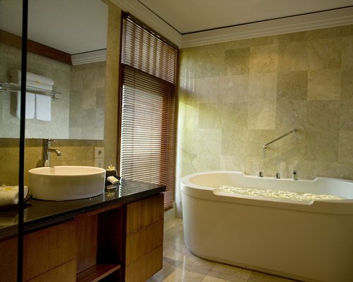 A bathroom with shower bathtub and closed sink vanity.