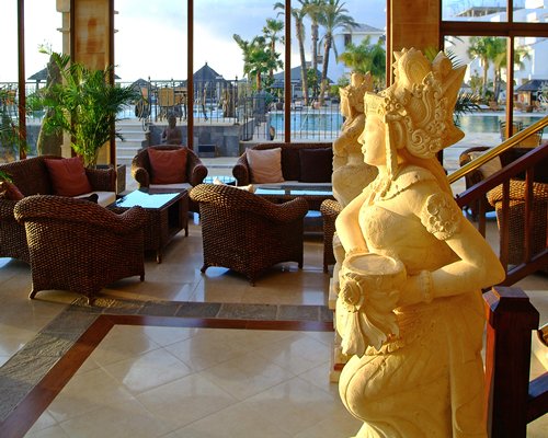 Lounge area with sculptures and outside view.