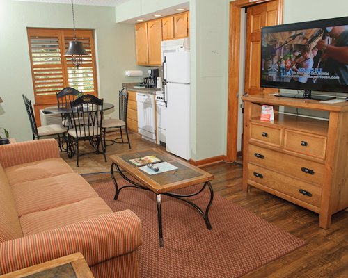 A well furnished living room with television and fireplace.