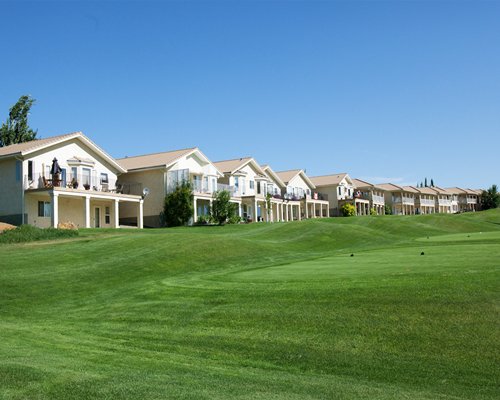 An exterior view of resort units alongside a manicured lawn.