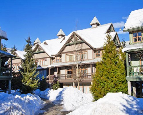 An exterior view of multi story resort units covered in snow.