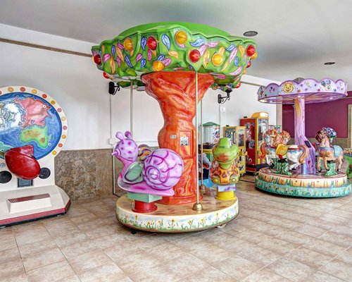 A view of two carousels in an indoor area.