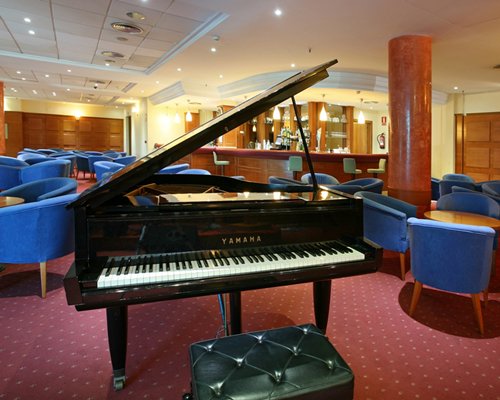 An indoor lounge area with a piano.