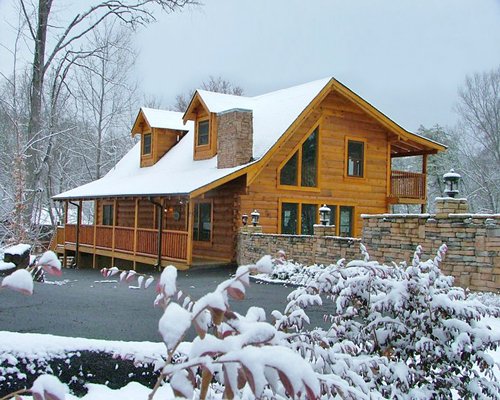 An exterior view of the Hideaway Hills Resort and covered in snow.