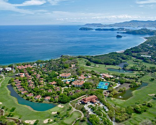 An aerial view of the Reserva Conchal Vacation Club alongside the water.