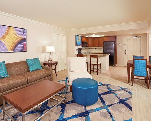 A well furnished living room with a television alongside bedroom.