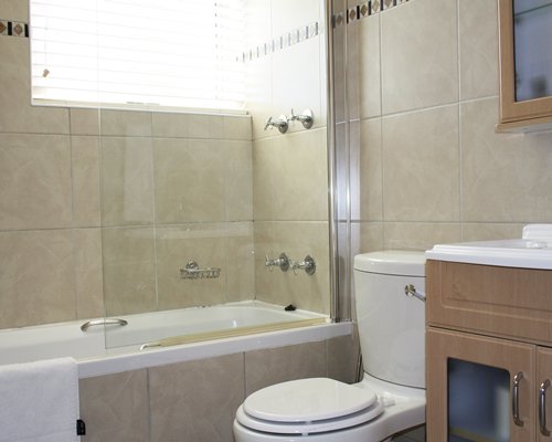 A bathroom with shower bathtub and closed sink vanity.