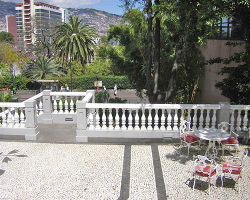 A scenic landscape and skyscrapers from the balcony with patio furniture.