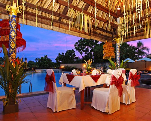 Private outdoor dining area alongside the swimming pool.