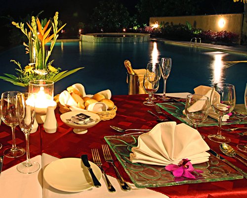 An outdoor fine dining area alongside the swimming pool.