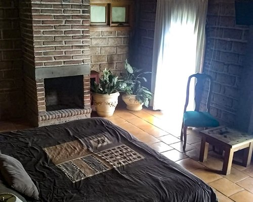 An open plan living and dining area with a fireplace and outside view.