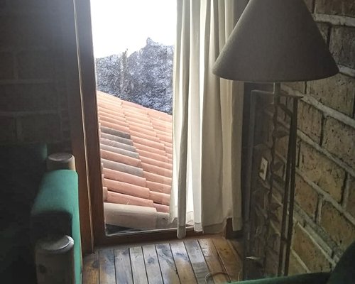 A well furnished living room with a fireplace and an outside view.