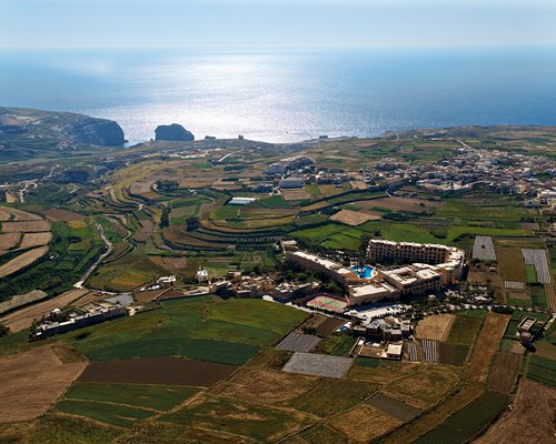 An aerial view of San Lawrenz Leisure Resort alongside the sea.