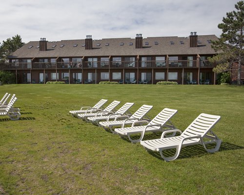 A view of chaise lounge chairs alongside resort units.