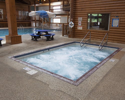 A hot tub alongside resort units and a swimming pool.
