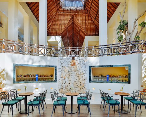 A resort bar and lounge area with high ceiling.
