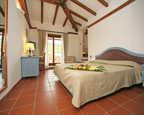 A well furnished bedroom with balcony.