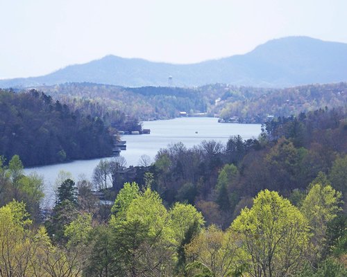 View of the lake surrounded by wooded area.