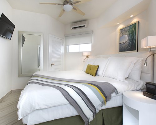 A well furnished bedroom with a television.