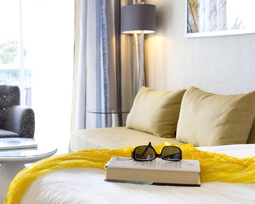 A well furnished living room with the bed and outside view.