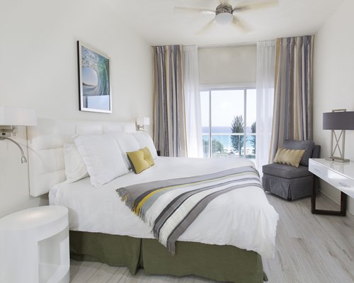 A well furnished bedroom with balcony.