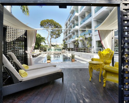 A view of chaise lounge chairs and patio alongside the swimming pool.
