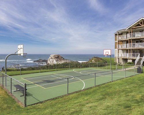 An outdoor volleyball court alongside the resort and the beach.