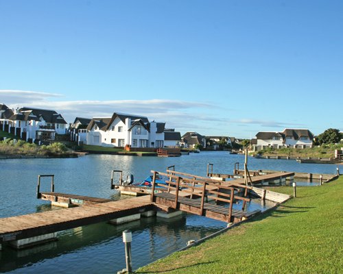 A scenic wooden pier leading to the waterfront alongside multiple units.