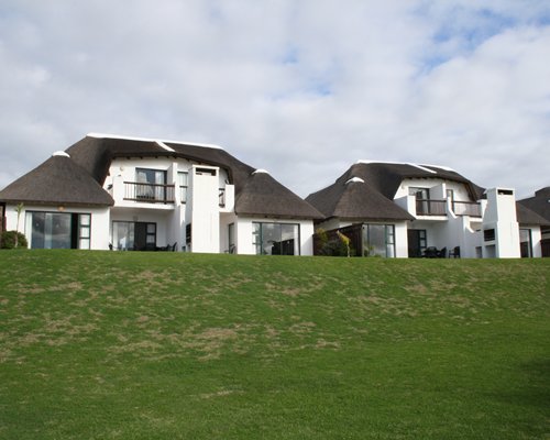 An exterior view of resort units alongside a lawn.