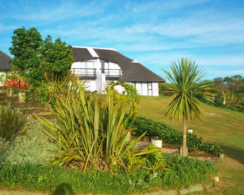 An exterior view of the resort with shrubs and landscaping.