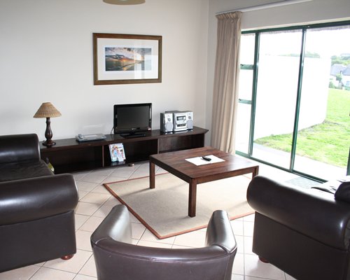 A well furnished living room with a television.