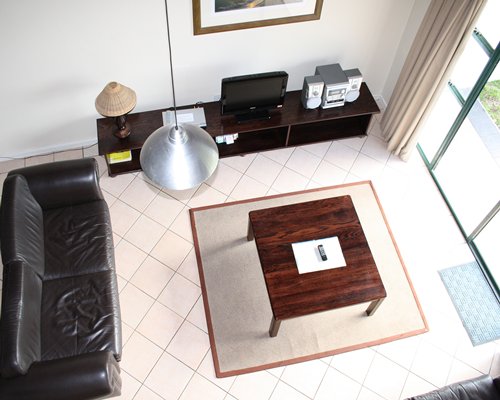 A well furnished living room with a television and patio.