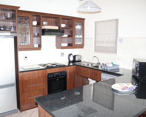 A well equipped kitchen with a microwave oven.