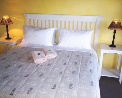 A well furnished bedroom with a queen bed.