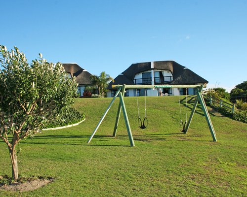 A view of an outdoor playscape with a swing.