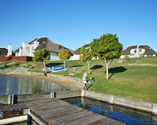 A wooden pier on the water alongside the resort.